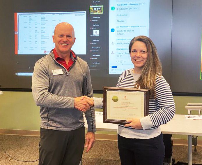 Student receiving certification from Program Director Jon Wellik